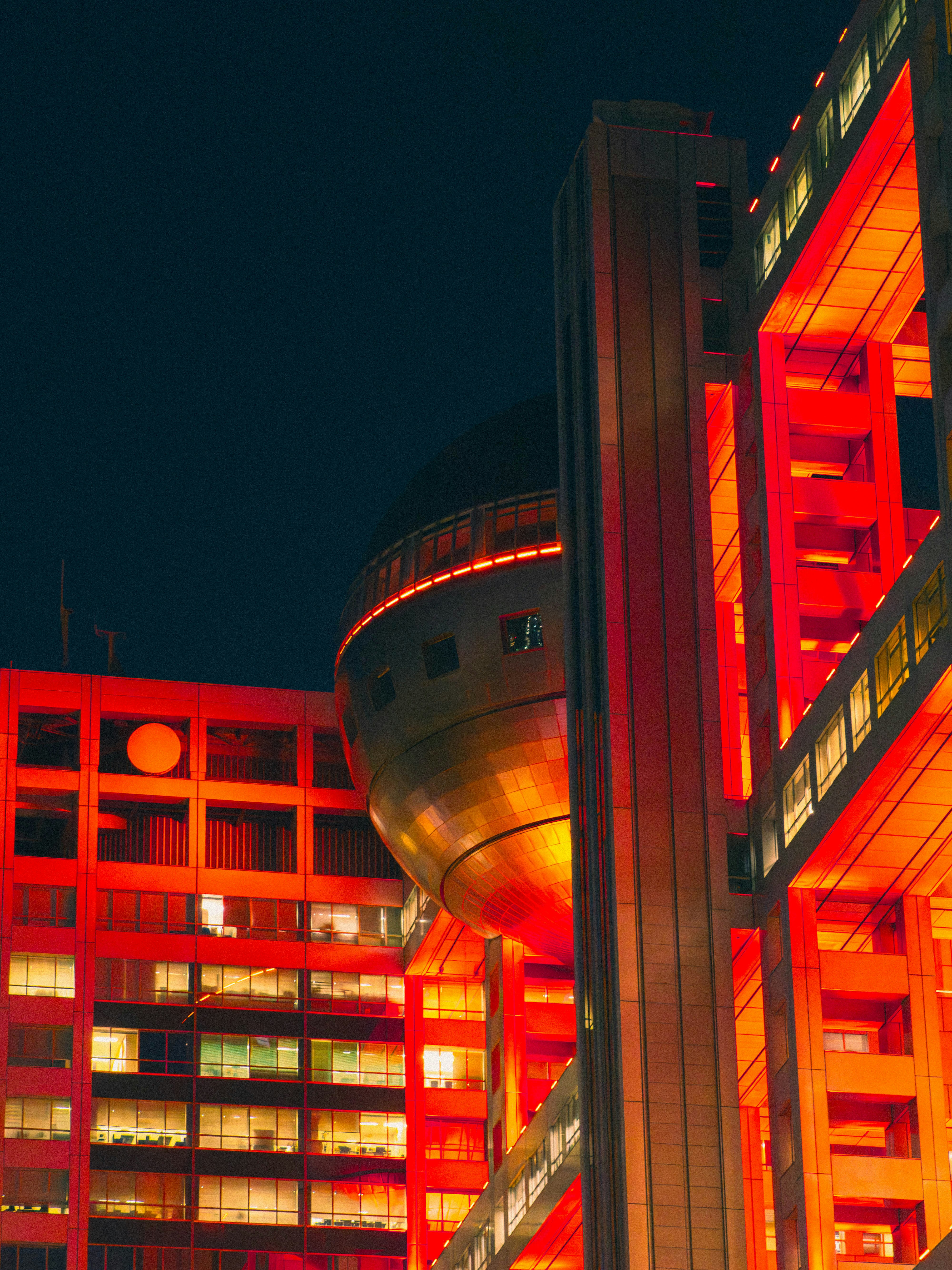 A shot of the Fuji TV headquarters down in Odaiba, Tokyo. The red glow reflects nicely off of the 360 silver globe viewing room.